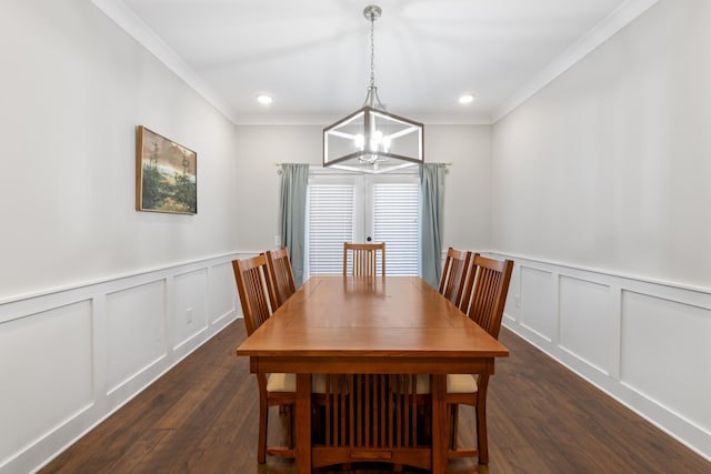 dining space featuring a decorative wall, a notable chandelier, crown molding, and dark wood-style flooring