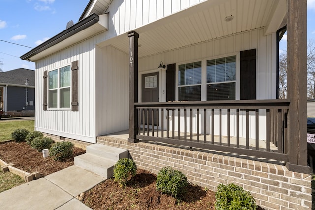 view of exterior entry with crawl space and a porch