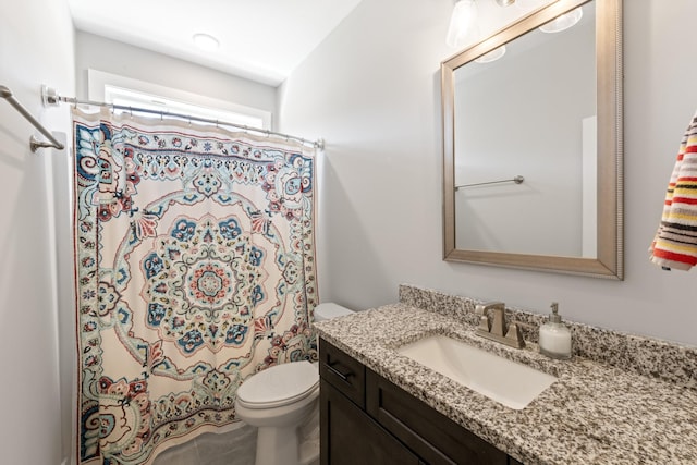 bathroom with a shower with curtain, toilet, and vanity