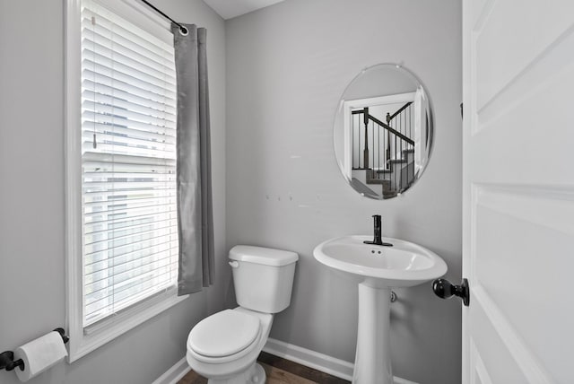bathroom featuring baseboards and toilet