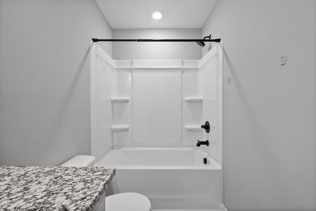 full bath featuring toilet, vanity, and shower / washtub combination