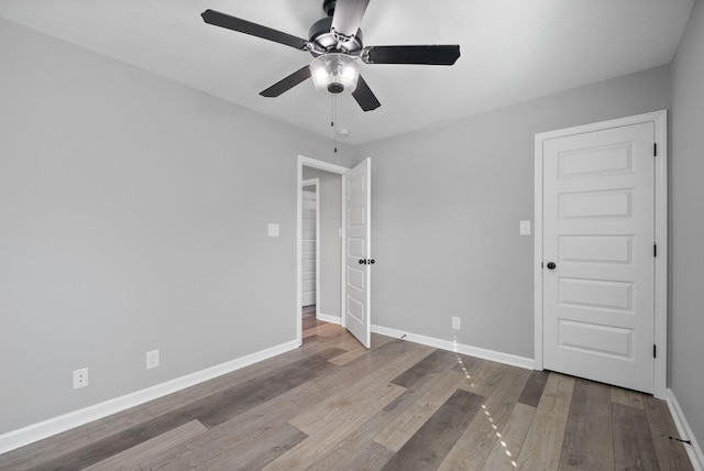 unfurnished bedroom with baseboards, ceiling fan, and wood finished floors