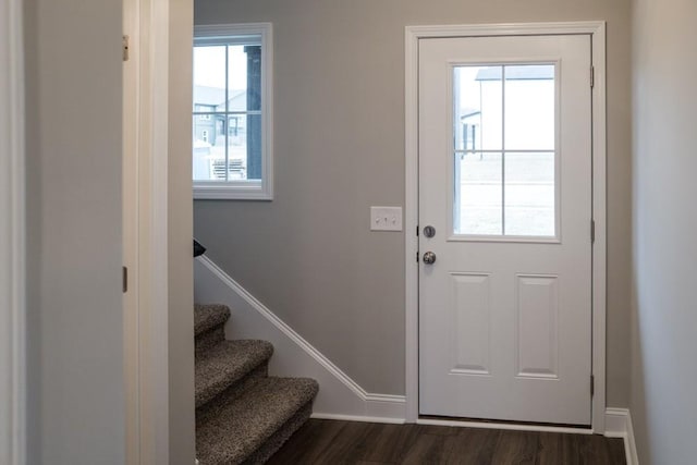 doorway featuring dark wood-style floors, stairway, and baseboards