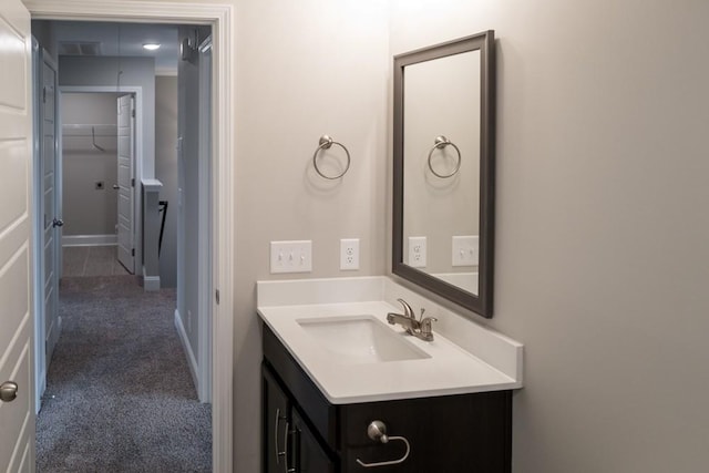 bathroom featuring vanity, baseboards, and visible vents