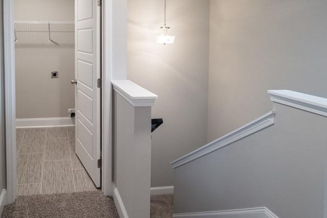 stairway featuring carpet and baseboards