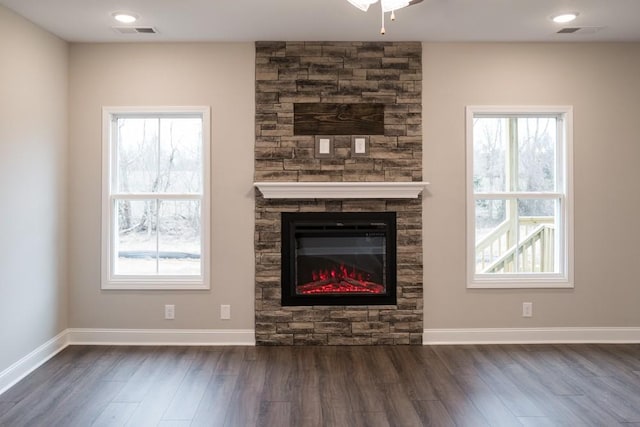 unfurnished living room featuring baseboards and dark wood finished floors