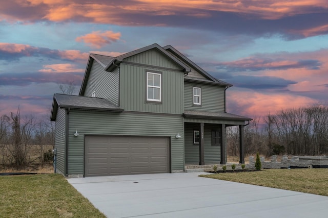 traditional-style house featuring a porch, an attached garage, a front lawn, and concrete driveway