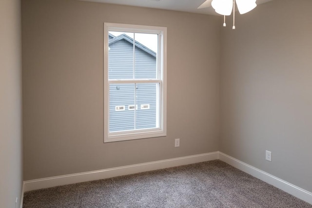 spare room featuring baseboards and carpet floors