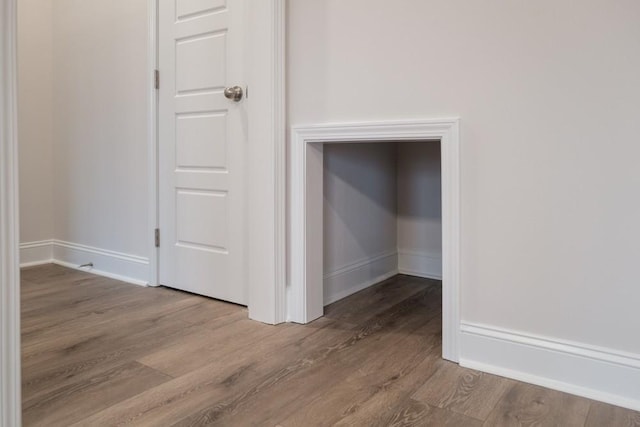 interior space with baseboards and wood finished floors