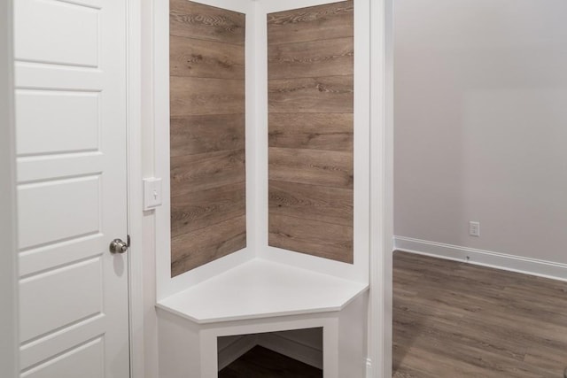 interior space with baseboards and wood finished floors