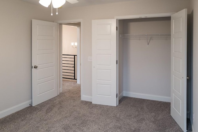 unfurnished bedroom featuring carpet, baseboards, and a closet