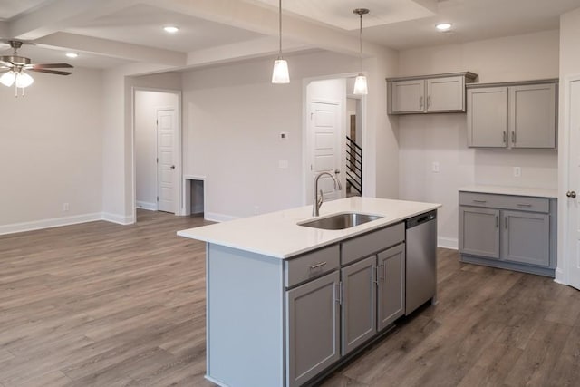 kitchen featuring a sink, gray cabinetry, wood finished floors, and stainless steel dishwasher