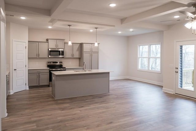 kitchen featuring dark wood-style floors, gray cabinets, appliances with stainless steel finishes, and a sink