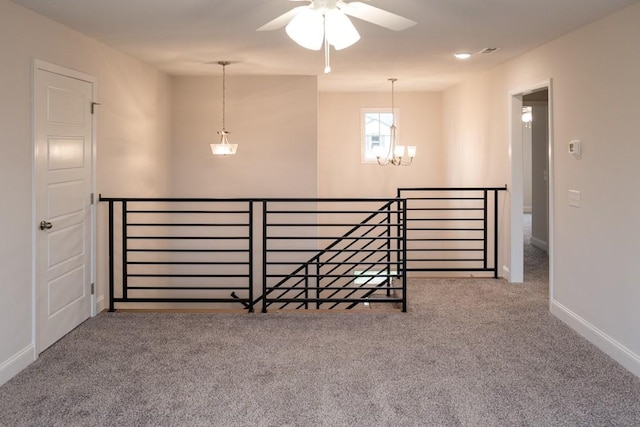 interior space with a chandelier, baseboards, and carpet