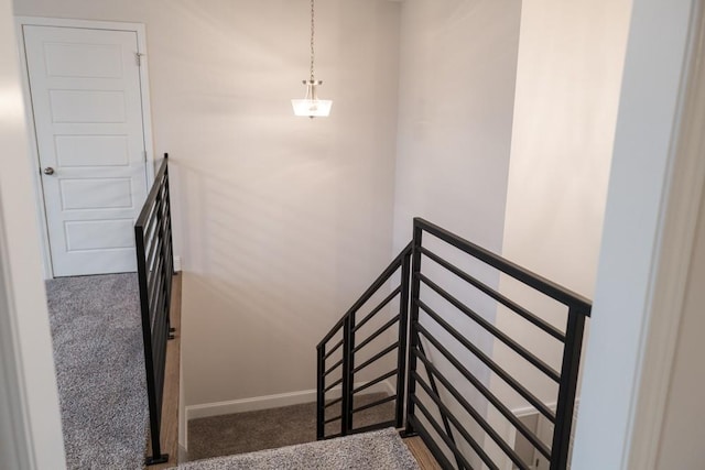 stairs with baseboards and carpet floors