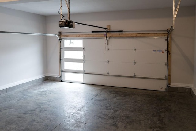 garage featuring a garage door opener and baseboards