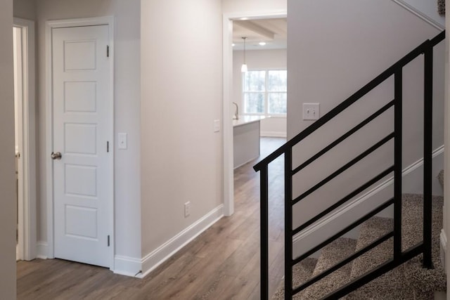 stairs with baseboards and wood finished floors