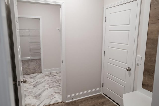 hallway with baseboards and dark wood-style flooring