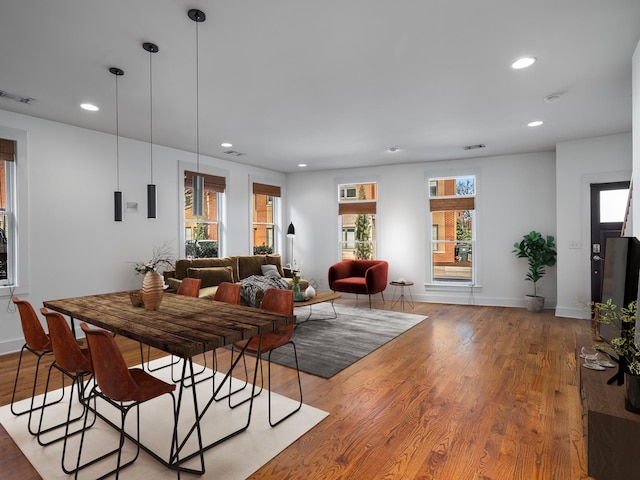 dining room with recessed lighting, wood finished floors, visible vents, and baseboards