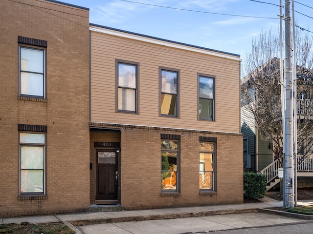 view of front of home featuring brick siding