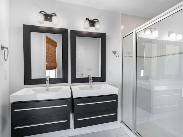 full bathroom with a sink, double vanity, and a shower stall