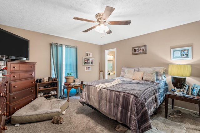 carpeted bedroom featuring connected bathroom, a ceiling fan, and a textured ceiling