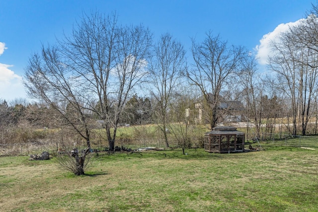 view of yard with an outdoor structure and fence