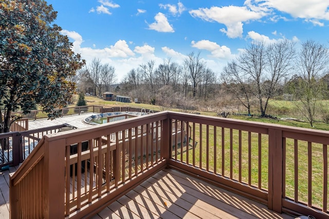 wooden deck with a yard and a covered pool