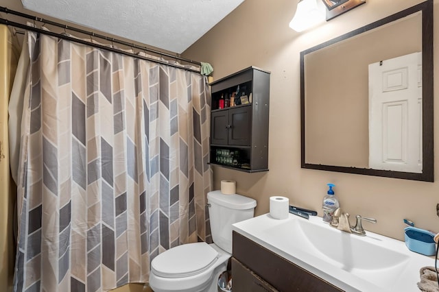 bathroom with a shower with shower curtain, a textured ceiling, toilet, and vanity