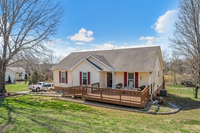 view of front facade with roof with shingles, central AC, a deck, and a front lawn