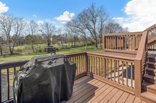 deck featuring a lawn and a grill