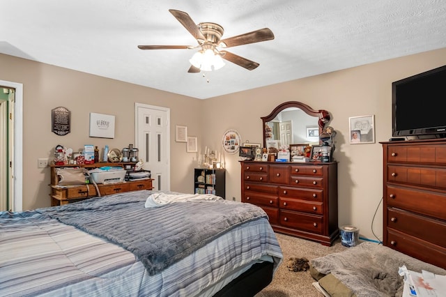 bedroom featuring a textured ceiling, ceiling fan, and carpet flooring