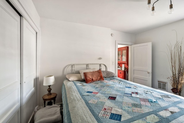 bedroom with a closet and visible vents