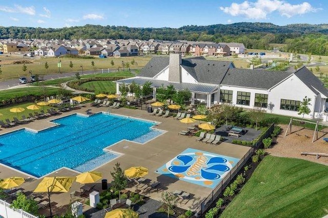 view of pool with a pergola, a patio area, and a residential view