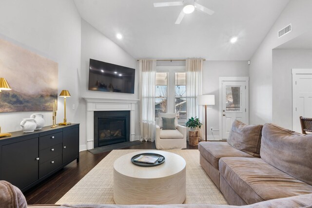 living area with dark wood-style floors, visible vents, a fireplace with flush hearth, recessed lighting, and ceiling fan