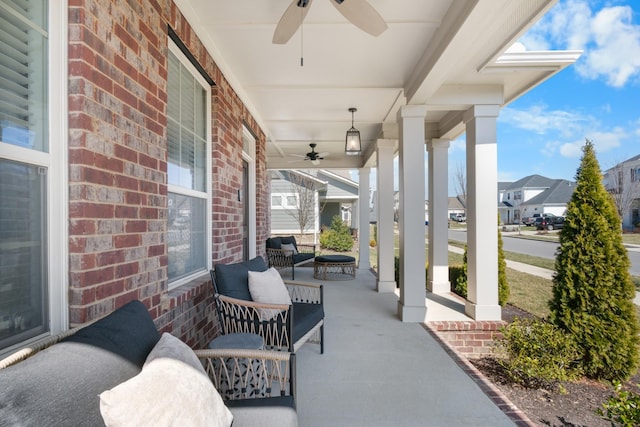 view of patio with a residential view, covered porch, and a ceiling fan