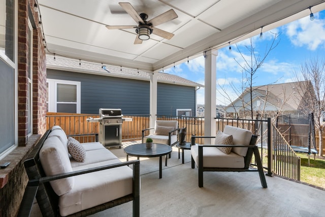 view of patio / terrace featuring fence, ceiling fan, grilling area, outdoor lounge area, and a trampoline