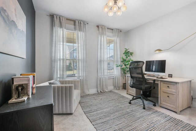 office with baseboards, a chandelier, and light carpet