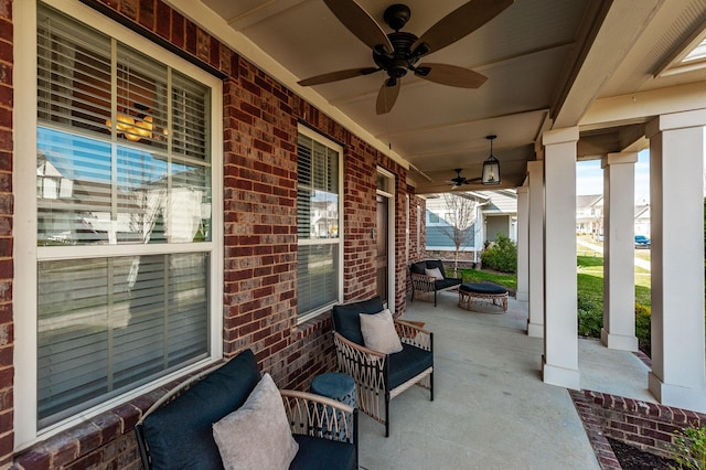 view of patio / terrace featuring a porch, a ceiling fan, and an outdoor fire pit