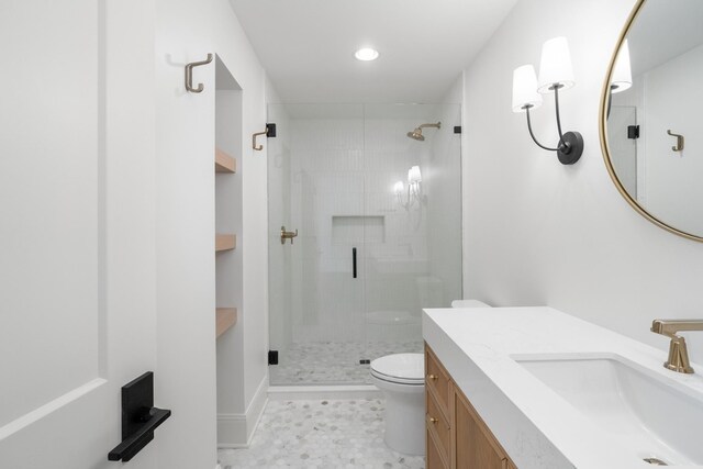 bathroom with a shower stall, toilet, and vanity