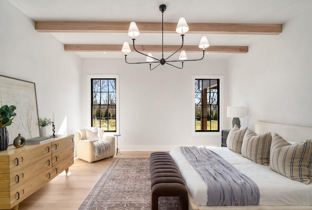 bedroom featuring an inviting chandelier, light wood-style floors, and beam ceiling