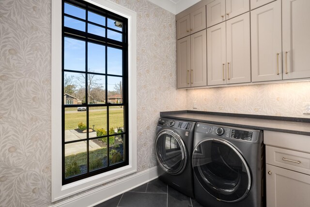 washroom featuring tile patterned floors, washing machine and dryer, cabinet space, and wallpapered walls