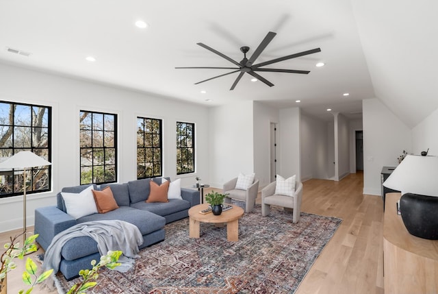 living room with light wood finished floors, visible vents, recessed lighting, and baseboards