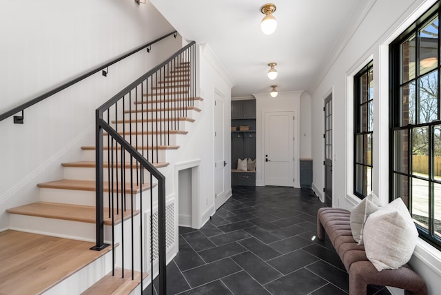 entrance foyer with stairs and ornamental molding