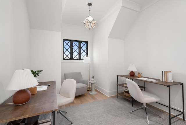 office featuring an inviting chandelier, baseboards, and wood finished floors