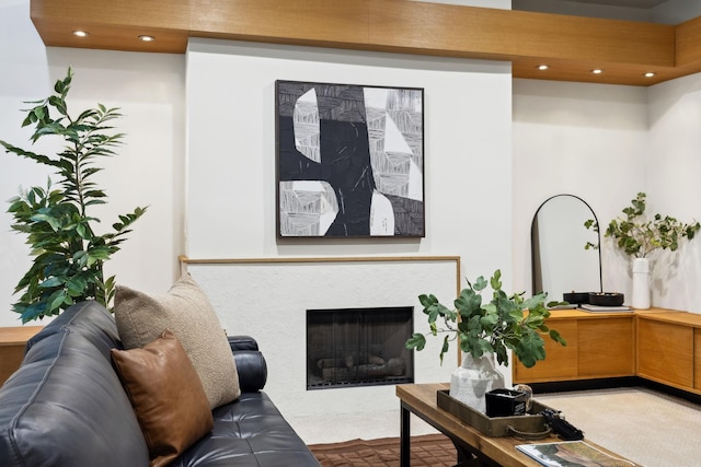 living area with carpet flooring, a fireplace with flush hearth, and recessed lighting