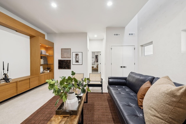 living room with visible vents, recessed lighting, and carpet floors