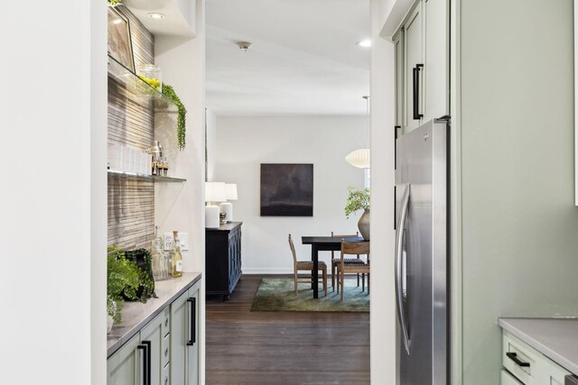 kitchen featuring light countertops, freestanding refrigerator, baseboards, and dark wood-style flooring