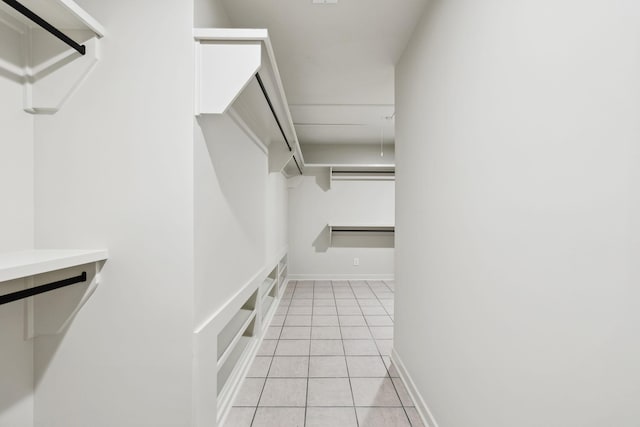 spacious closet with light tile patterned floors