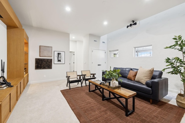 carpeted living area featuring visible vents, recessed lighting, and baseboards